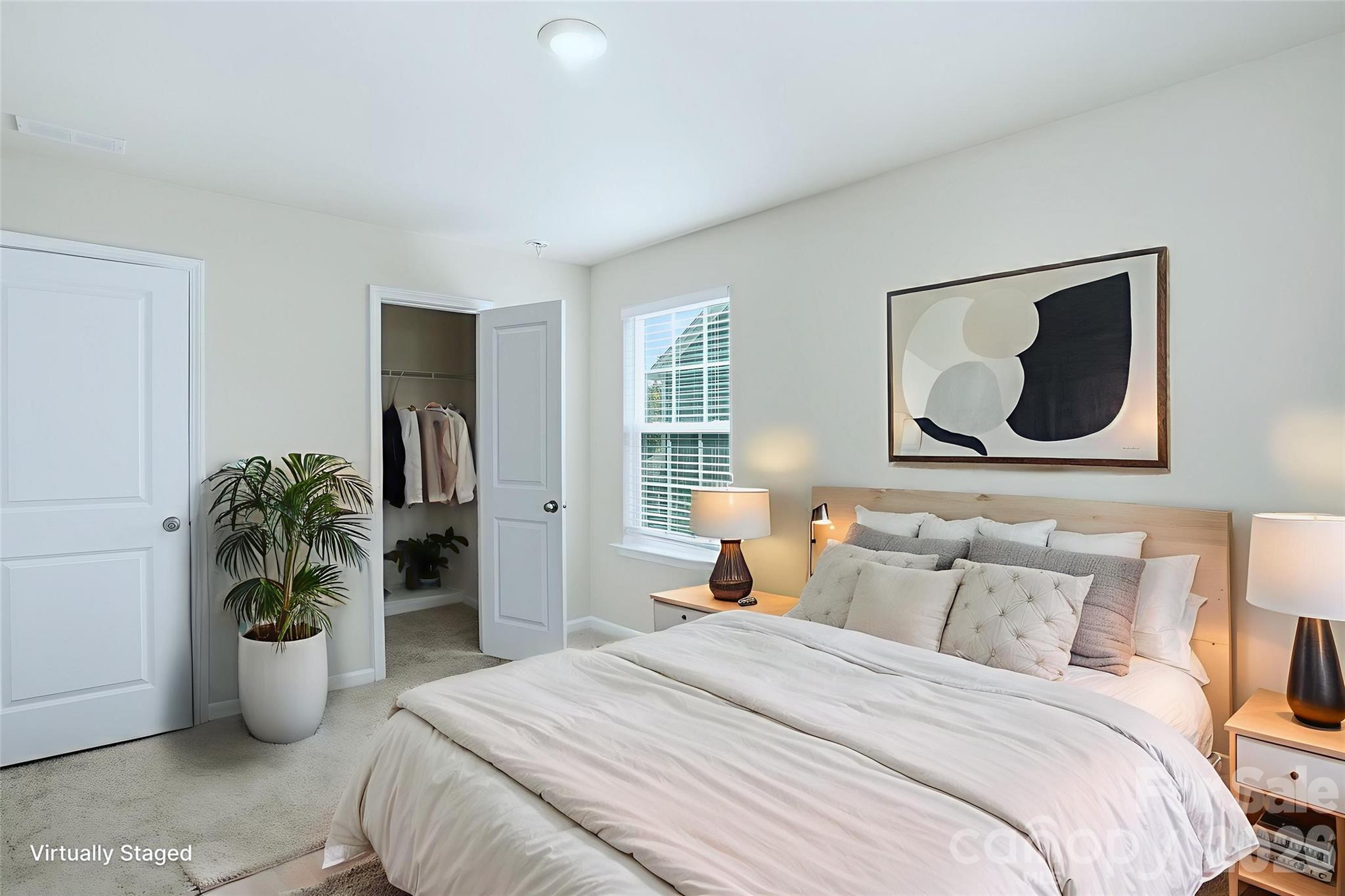 124 Tackle Troutman, NC 28166 - Photo 11 of 44 a bedroom with a bed and a potted plant