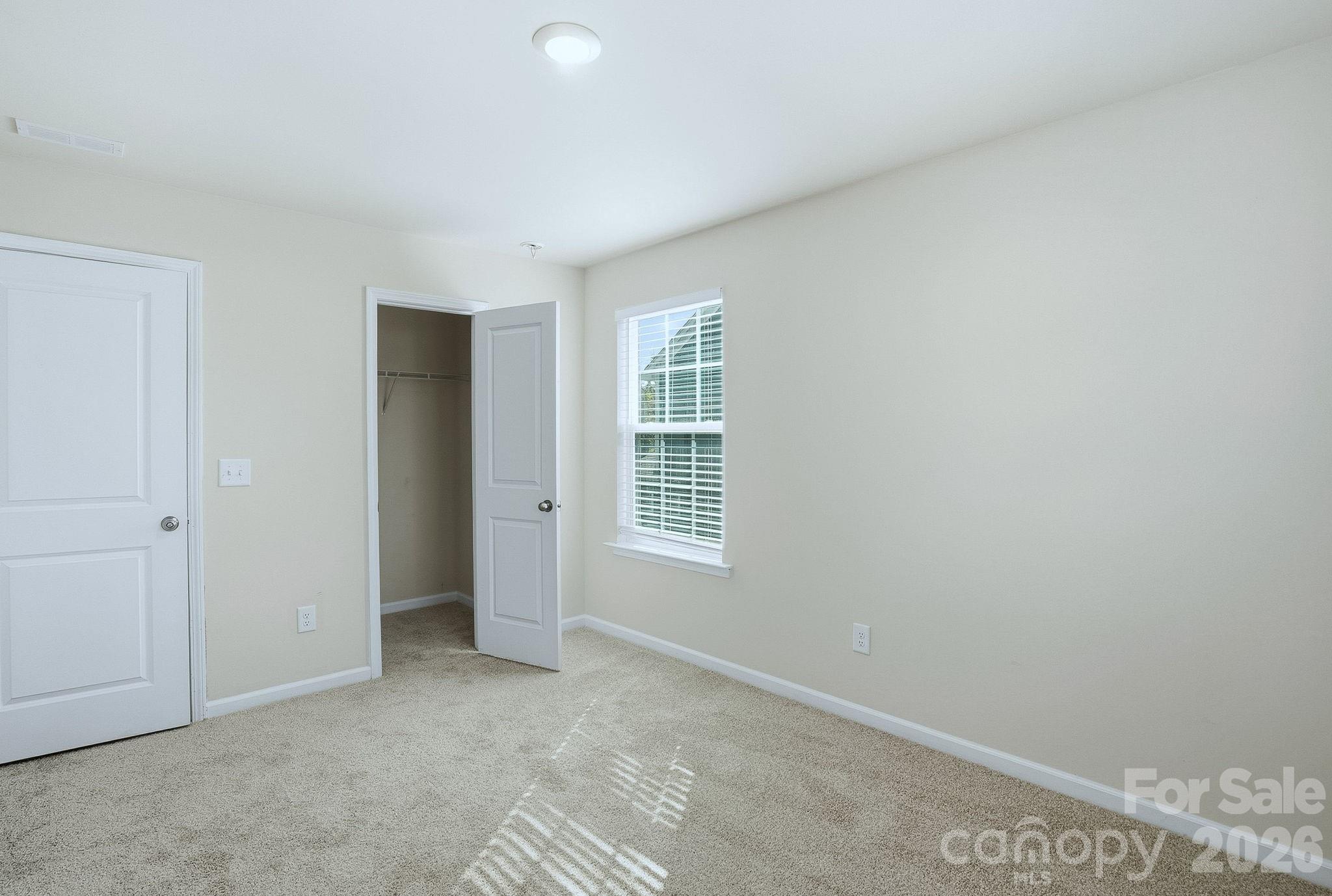 124 Tackle Troutman, NC 28166 - Photo 12 of 44 a view of an empty room with a window