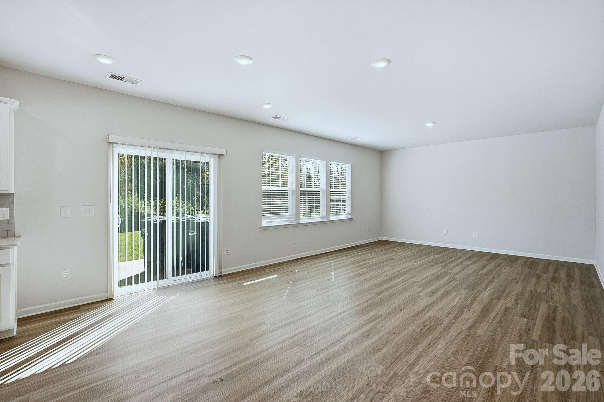 124 Tackle Troutman, NC 28166 - Photo 16 of 44 an empty room with wooden floor and windows