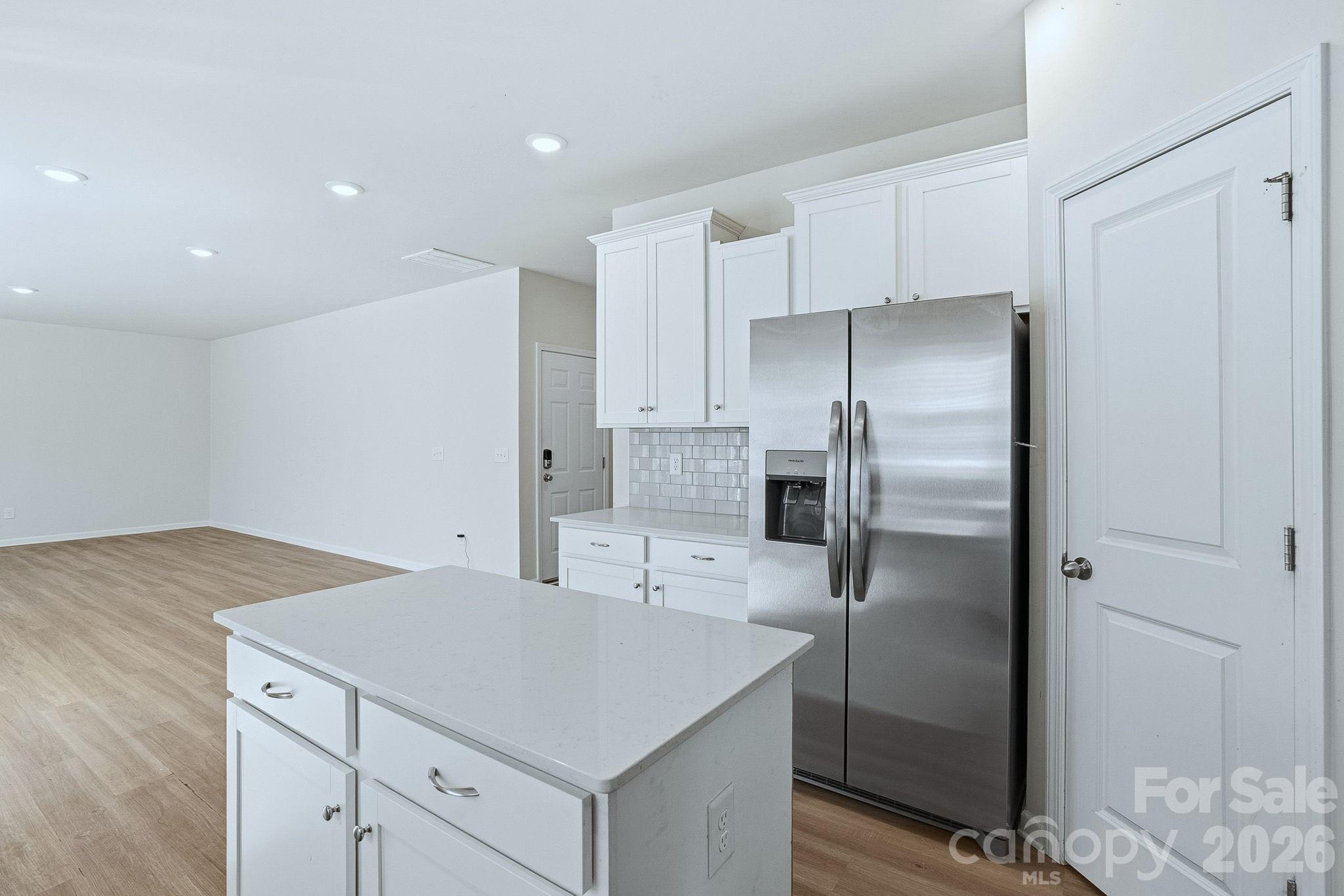 124 Tackle Troutman, NC 28166 - Photo 20 of 44 a kitchen with a refrigerator a sink and cabinets