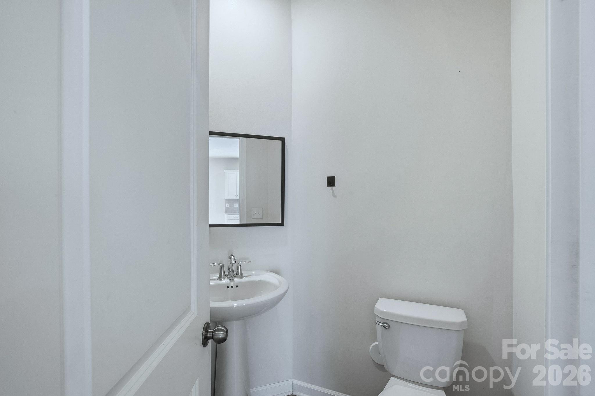 124 Tackle Troutman, NC 28166 - Photo 22 of 44 a bathroom with a sink a toilet and a mirror