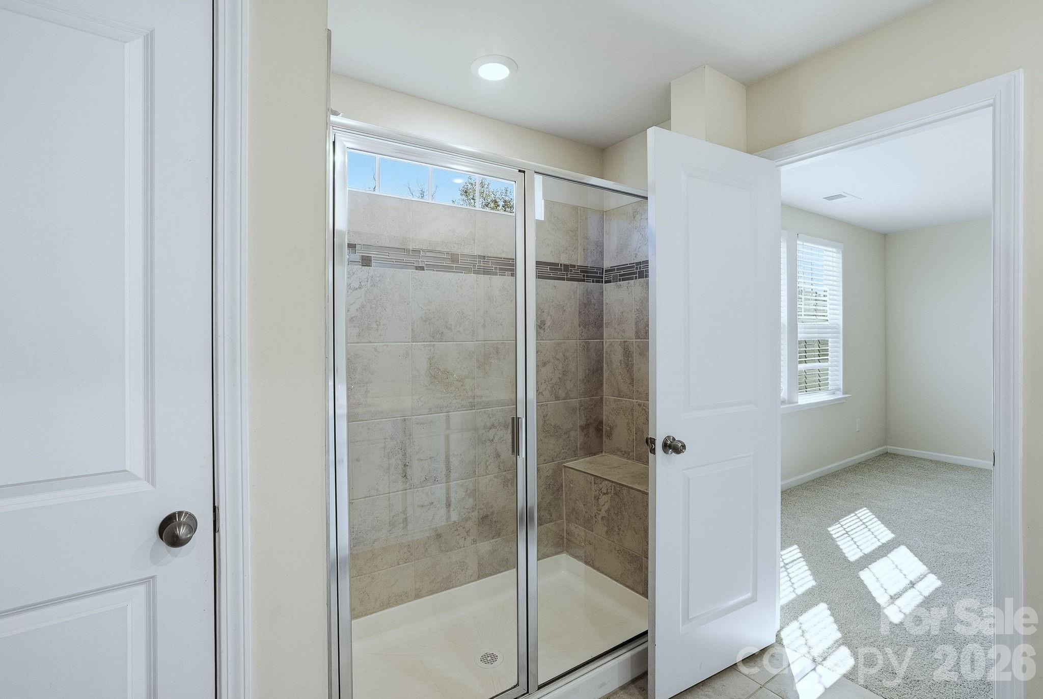 124 Tackle Troutman, NC 28166 - Photo 30 of 44 a bathroom with a glass shower door