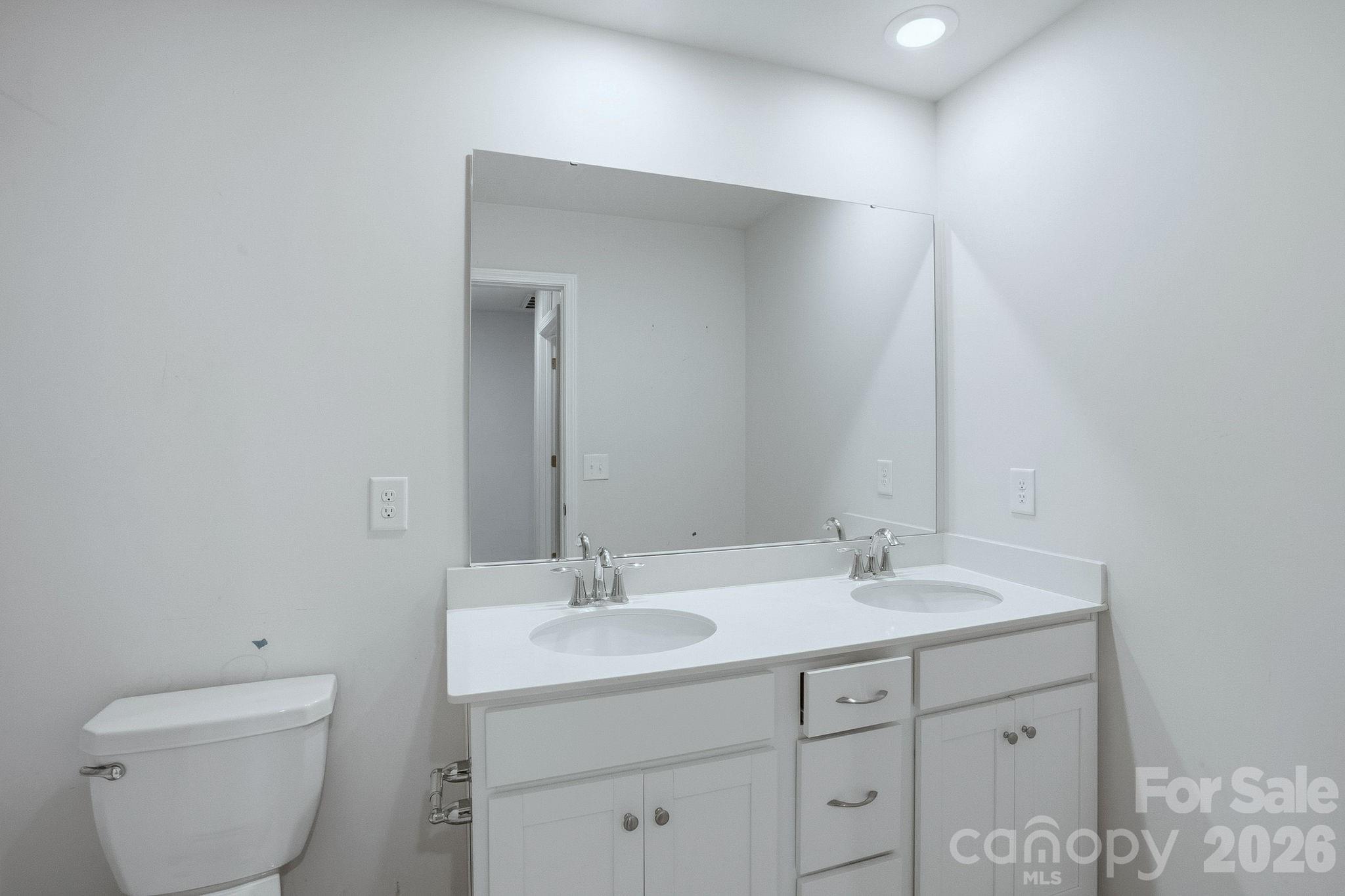 124 Tackle Troutman, NC 28166 - Photo 33 of 44 a bathroom with a toilet sink and mirror