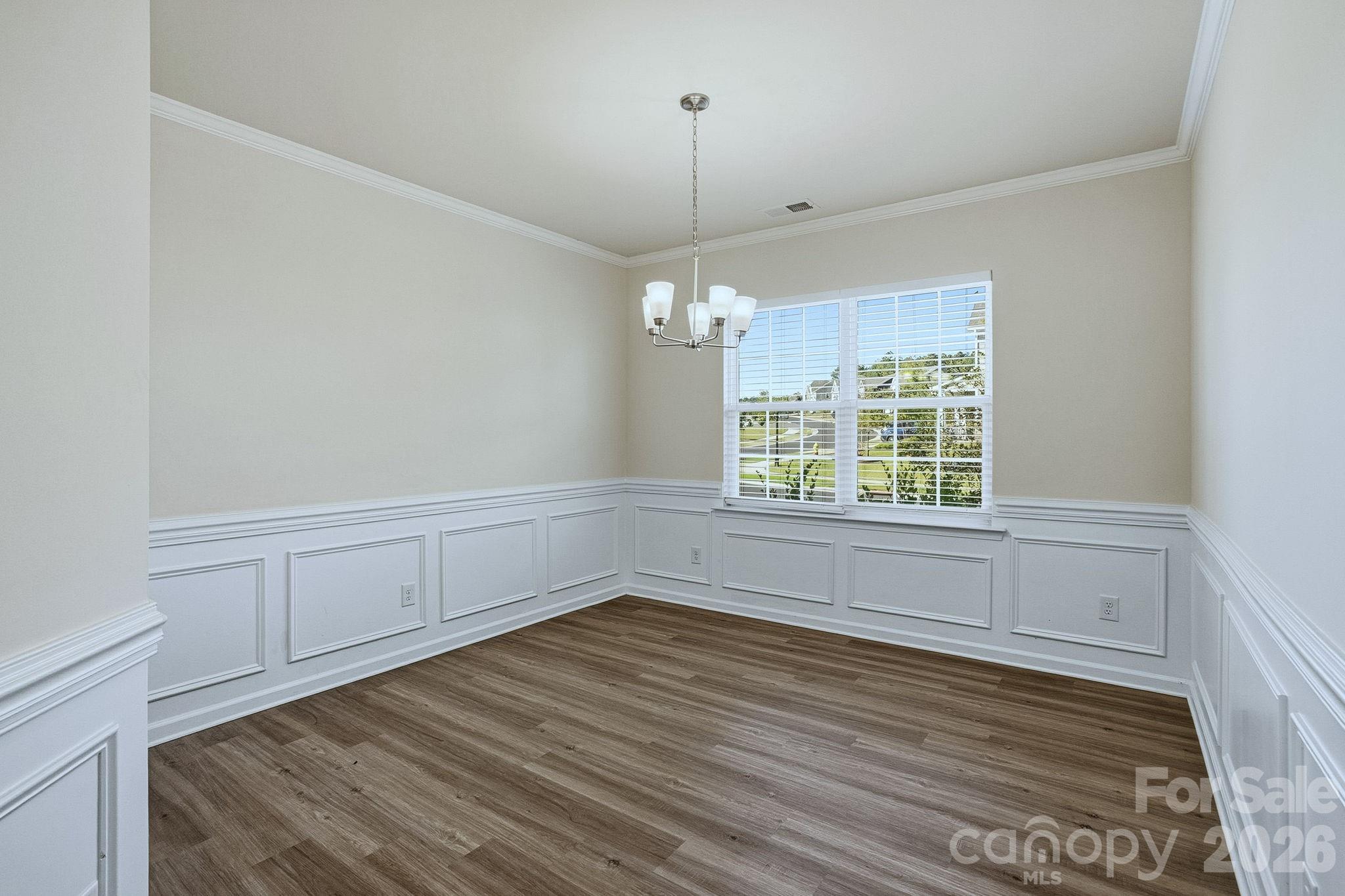 124 Tackle Troutman, NC 28166 - Photo 4 of 44 a view of a room with wooden floor and windows
