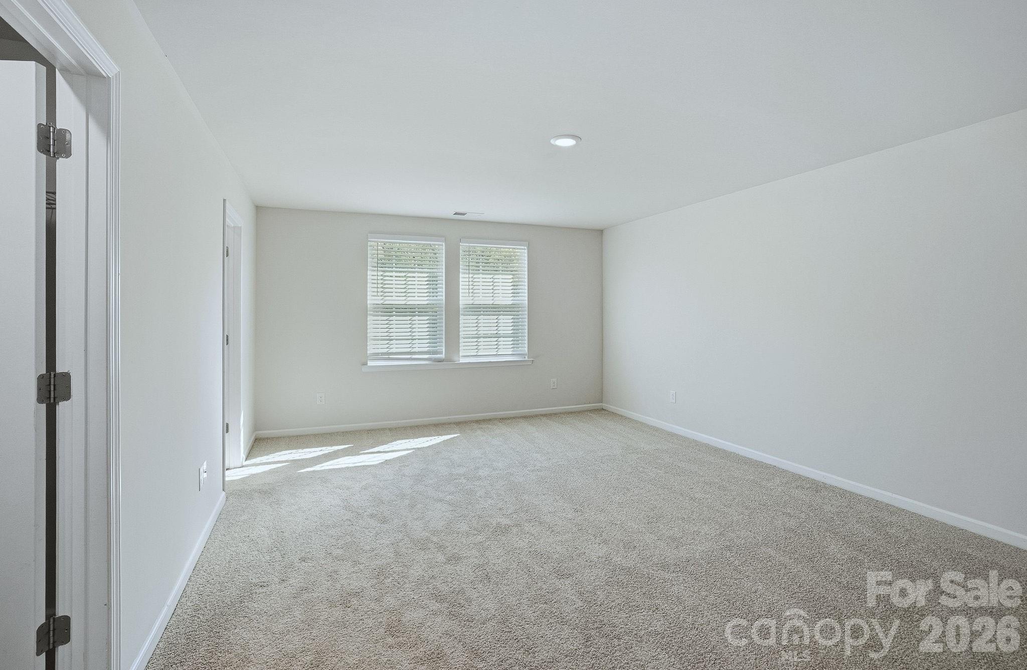 124 Tackle Troutman, NC 28166 - Photo 8 of 44 an empty room with windows