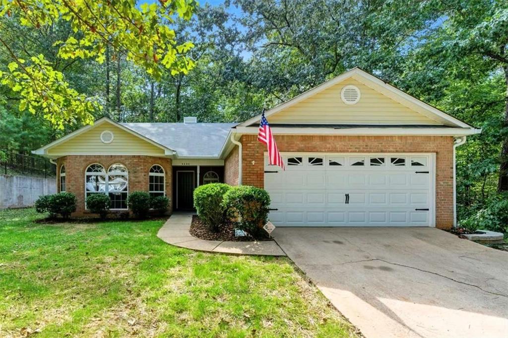 8060 Longleaf Drive Villa Rica, GA 30180 - Photo 1 of 1 a front view of a house with a garden