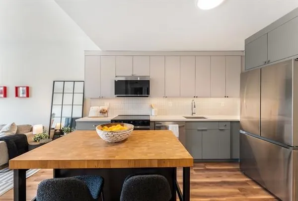 a kitchen with a sink refrigerator and microwave