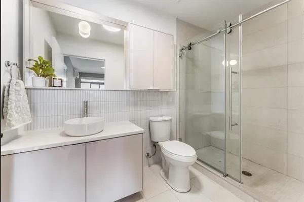 a bathroom with a sink toilet and shower