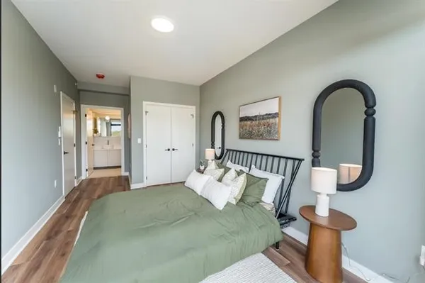 a bedroom with furniture and a large mirror