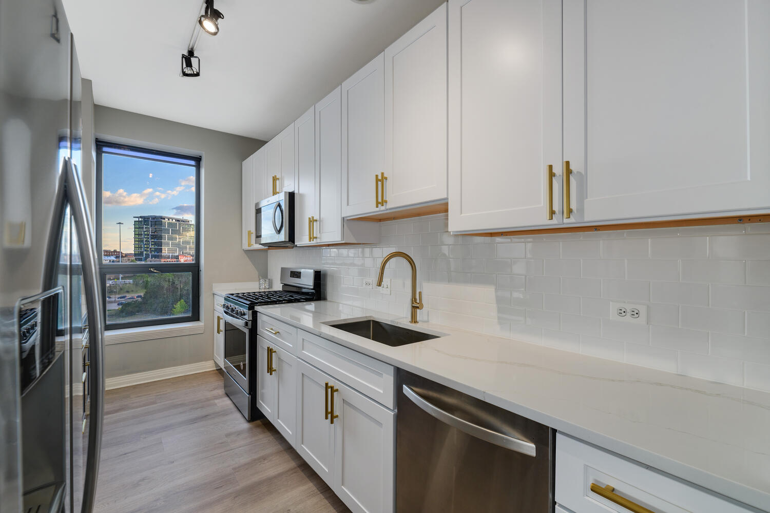 859 West Erie Street, Unit 604 Chicago, IL 60642 - Photo 11 of 32 a kitchen with stainless steel appliances granite countertop a sink a stove and a refrigerator