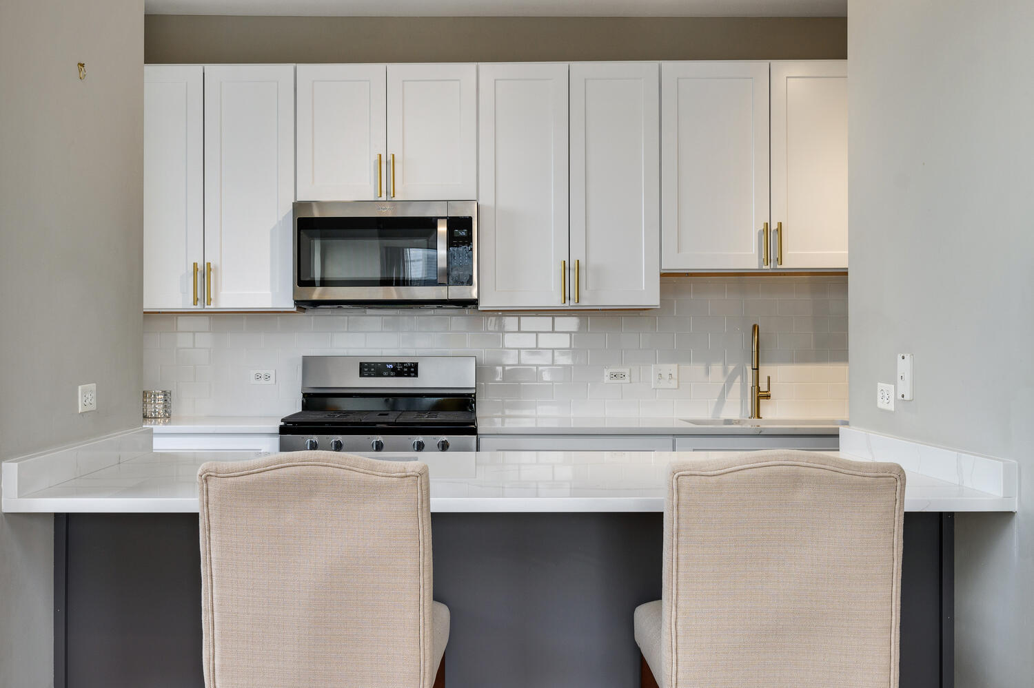 859 West Erie Street, Unit 604 Chicago, IL 60642 - Photo 13 of 32 a kitchen with granite countertop white cabinets and black appliances