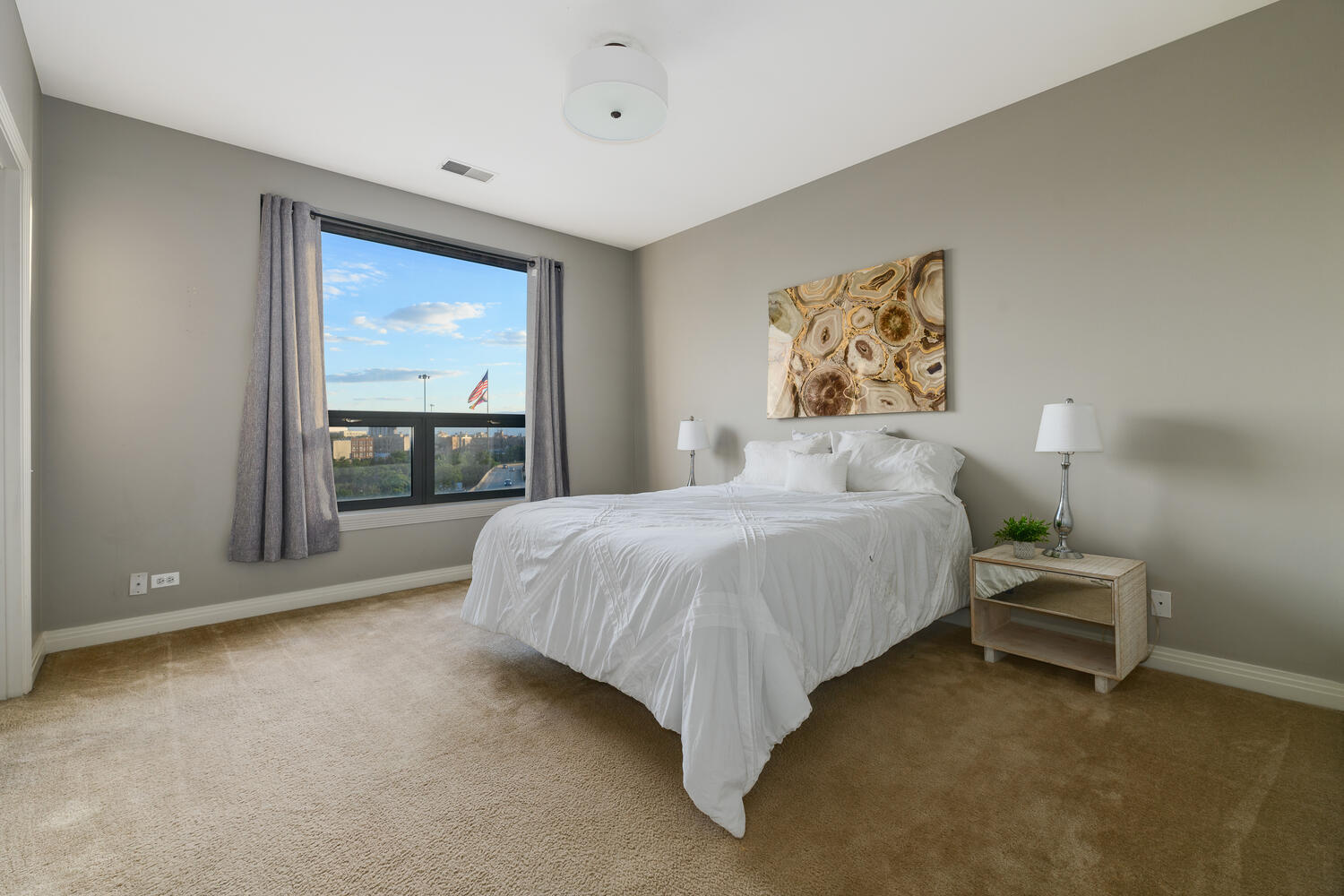 859 West Erie Street, Unit 604 Chicago, IL 60642 - Photo 15 of 32 a spacious bedroom with a bed and a window