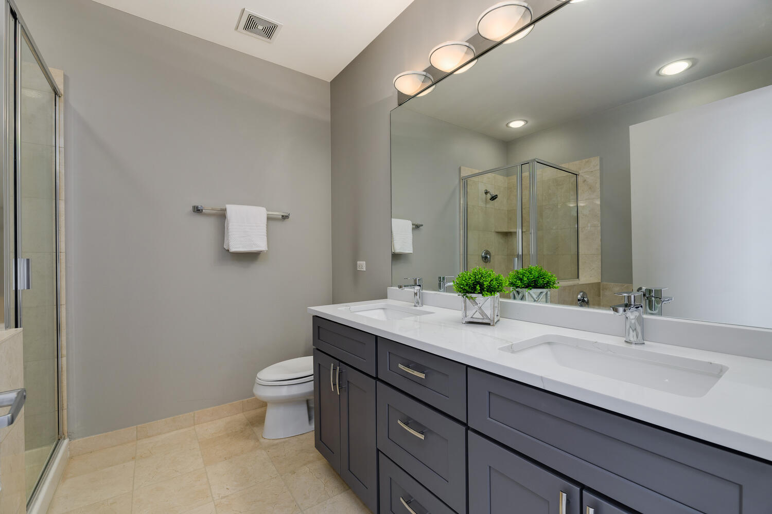 859 West Erie Street, Unit 604 Chicago, IL 60642 - Photo 17 of 32 a bathroom with a granite countertop sink a toilet and mirror