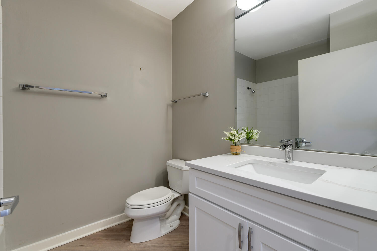 859 West Erie Street, Unit 604 Chicago, IL 60642 - Photo 23 of 32 a bathroom with a sink a toilet and a mirror