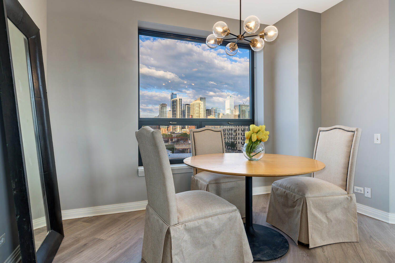 859 West Erie Street, Unit 604 Chicago, IL 60642 - Photo 6 of 32 a view of a dining room with furniture a chandelier and wooden floor