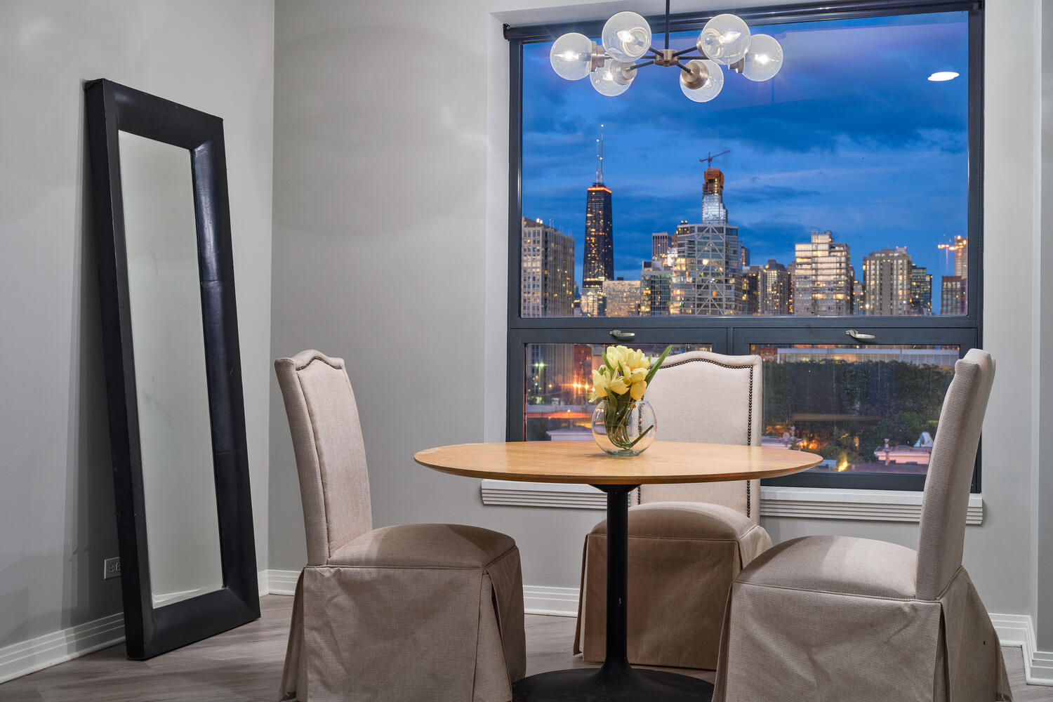859 West Erie Street, Unit 604 Chicago, IL 60642 - Photo 8 of 32 a dining room with furniture and chandelier