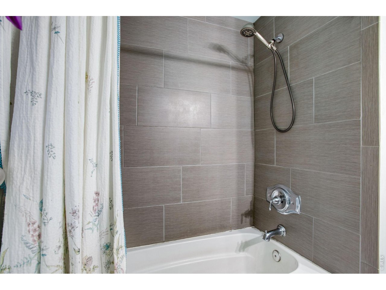 2106 13th Street Greeley, CO 80631 - Photo 21 of 42 Shared Hall Bath: Surround for the tub and shower has all been updated.