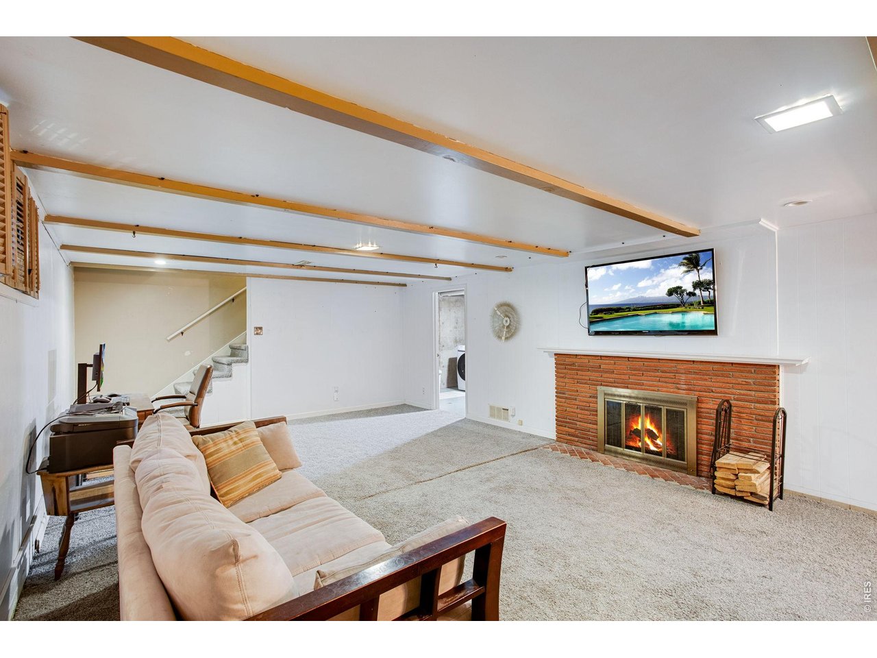 2106 13th Street Greeley, CO 80631 - Photo 29 of 42 Basement: Basement TV and TV mount are included!! Check out the stonework on that wood burning fireplace!
