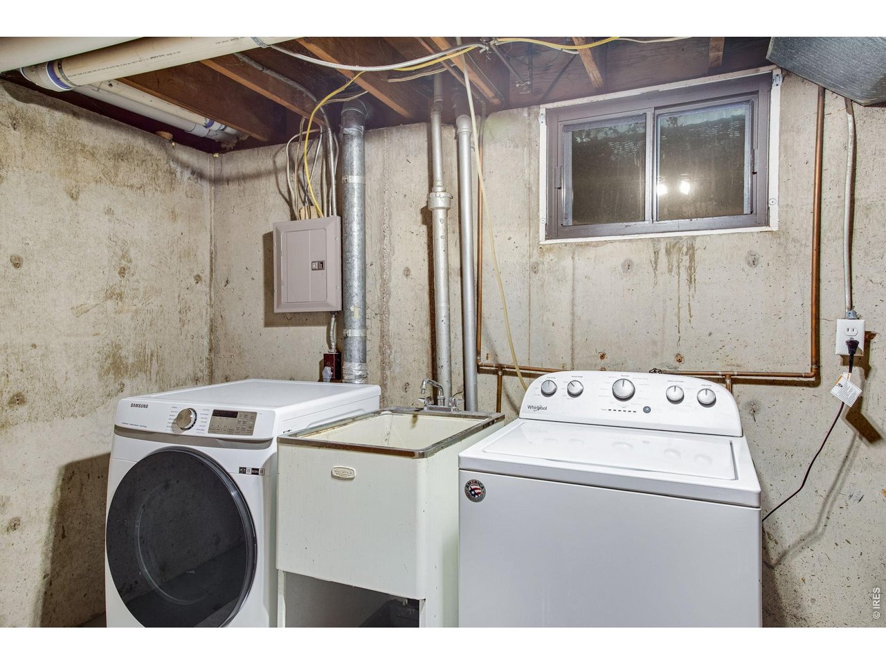 2106 13th Street Greeley, CO 80631 - Photo 30 of 42 Basement: Laundry room, washer and dryer stay with a large utility sink between them.