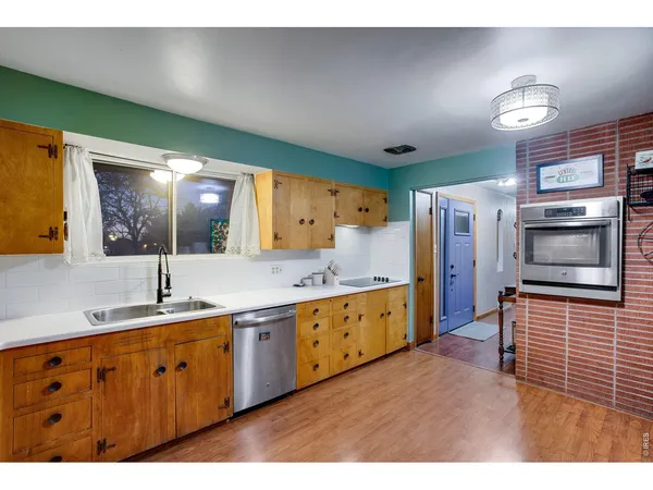 a kitchen with stainless steel appliances granite countertop a refrigerator and a stove
