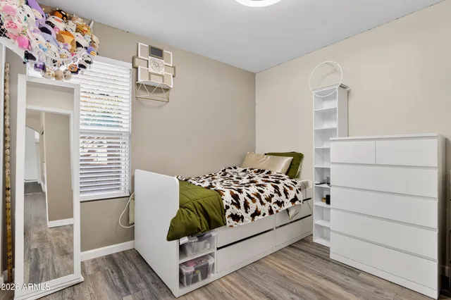 a bedroom with a bed and a window