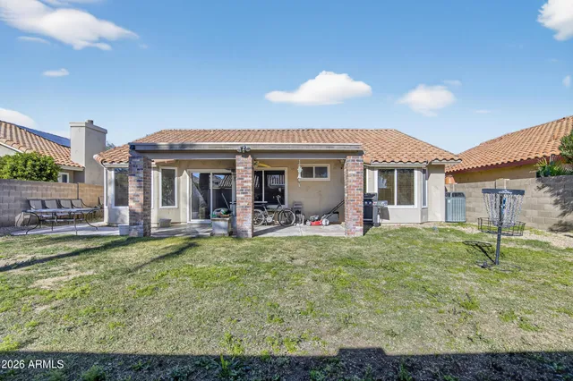 a view of a house with a backyard porch and sitting area