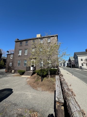 a view of a building with wooden fence
