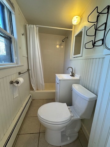 25 State Street, Unit 1 Marblehead, MA 01945 - Photo 4 of 8 a white toilet sitting next to a bathroom sink and a shower