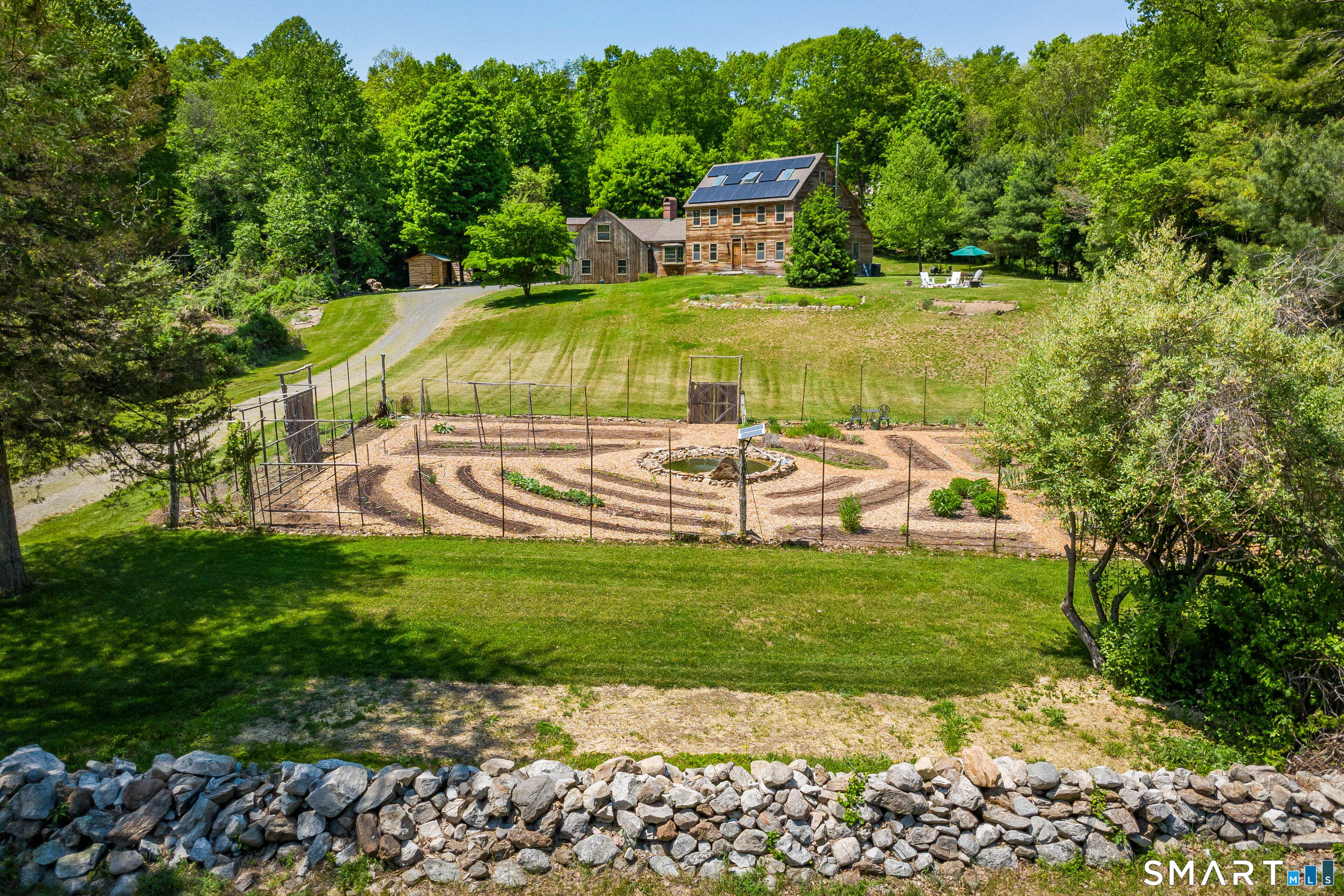 174 Huntingtown Road Newtown, CT 06470 - Photo 2 of 40 a garden view with a sitting space