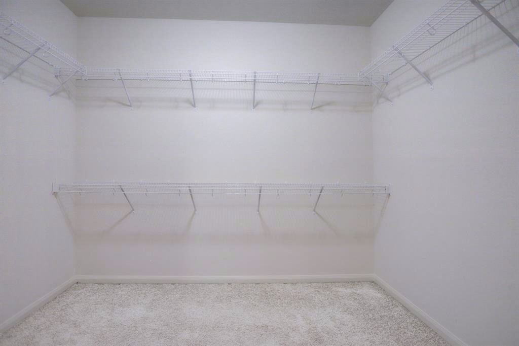 1303 Emerald Stone Drive Rosharon, TX 77583 - Photo 15 of 25 Large walk-in closet providing plenty of room for clothing, shoes, and everyday organization.