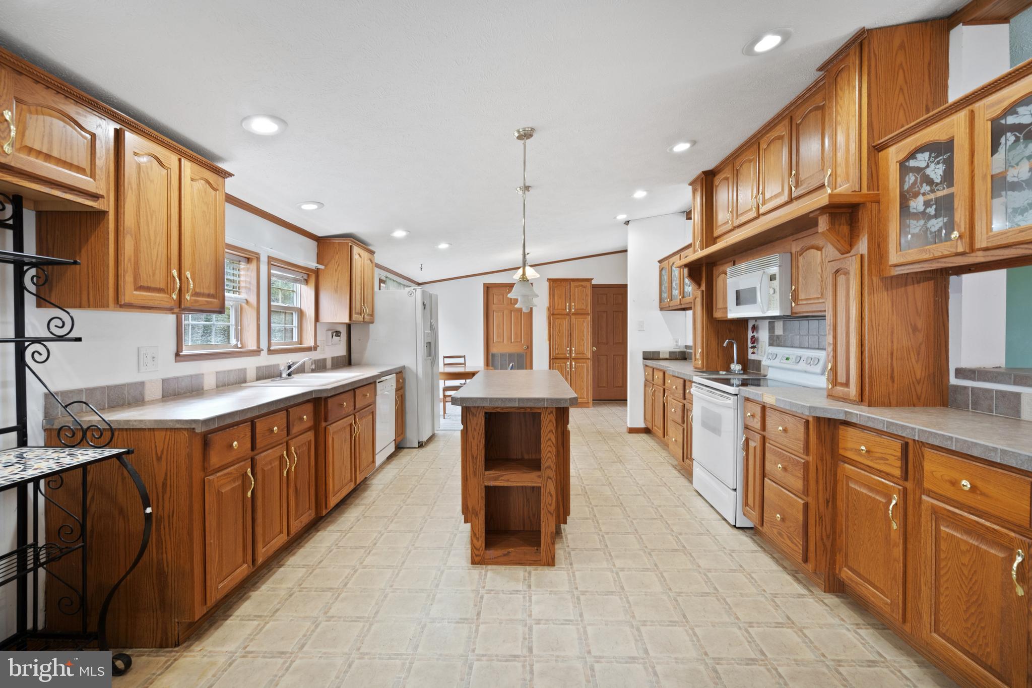 305 Bedington Road Martinsburg, WV 25404 - Photo 2 of 35 a large kitchen with stainless steel appliances kitchen island granite countertop a large kitchen island a stove a sink a window and a dining table