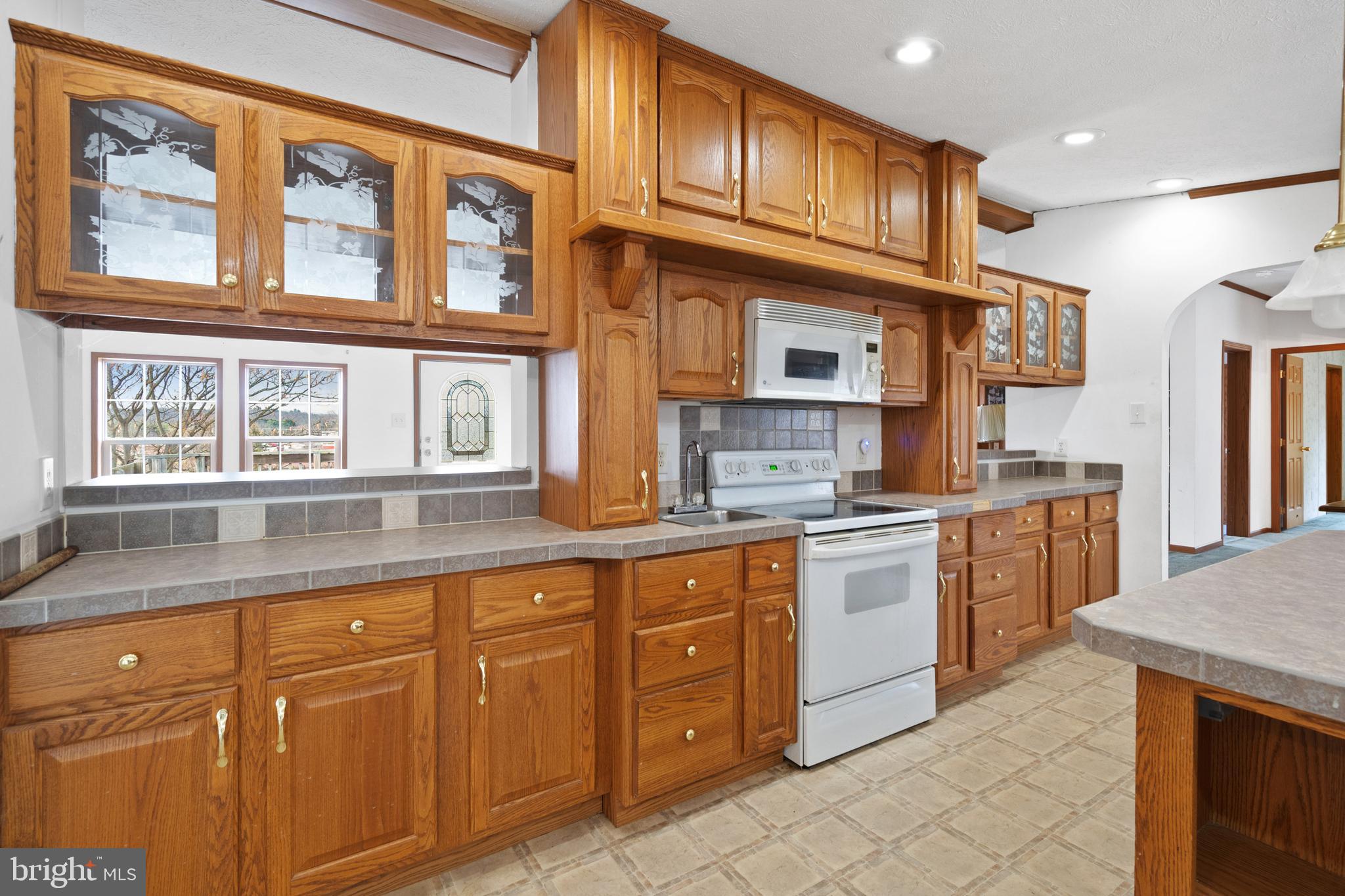 305 Bedington Road Martinsburg, WV 25404 - Photo 8 of 35 a kitchen with cabinets wooden floor and a window