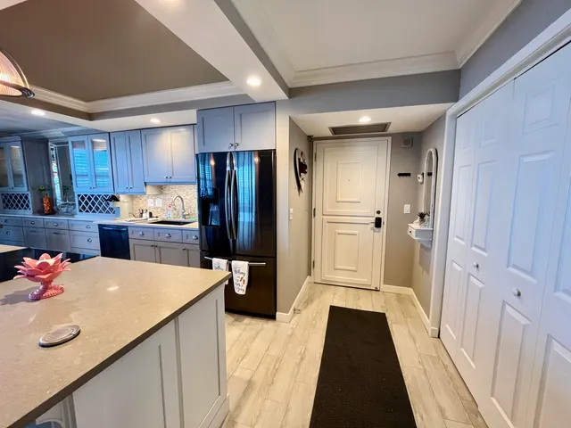 a living room with furniture a flat screen tv and a large window