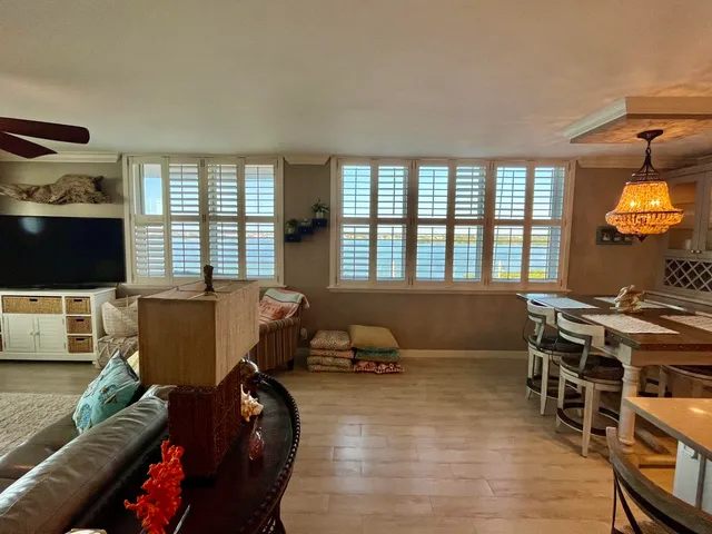 a bedroom with a bed wooden floor and a window