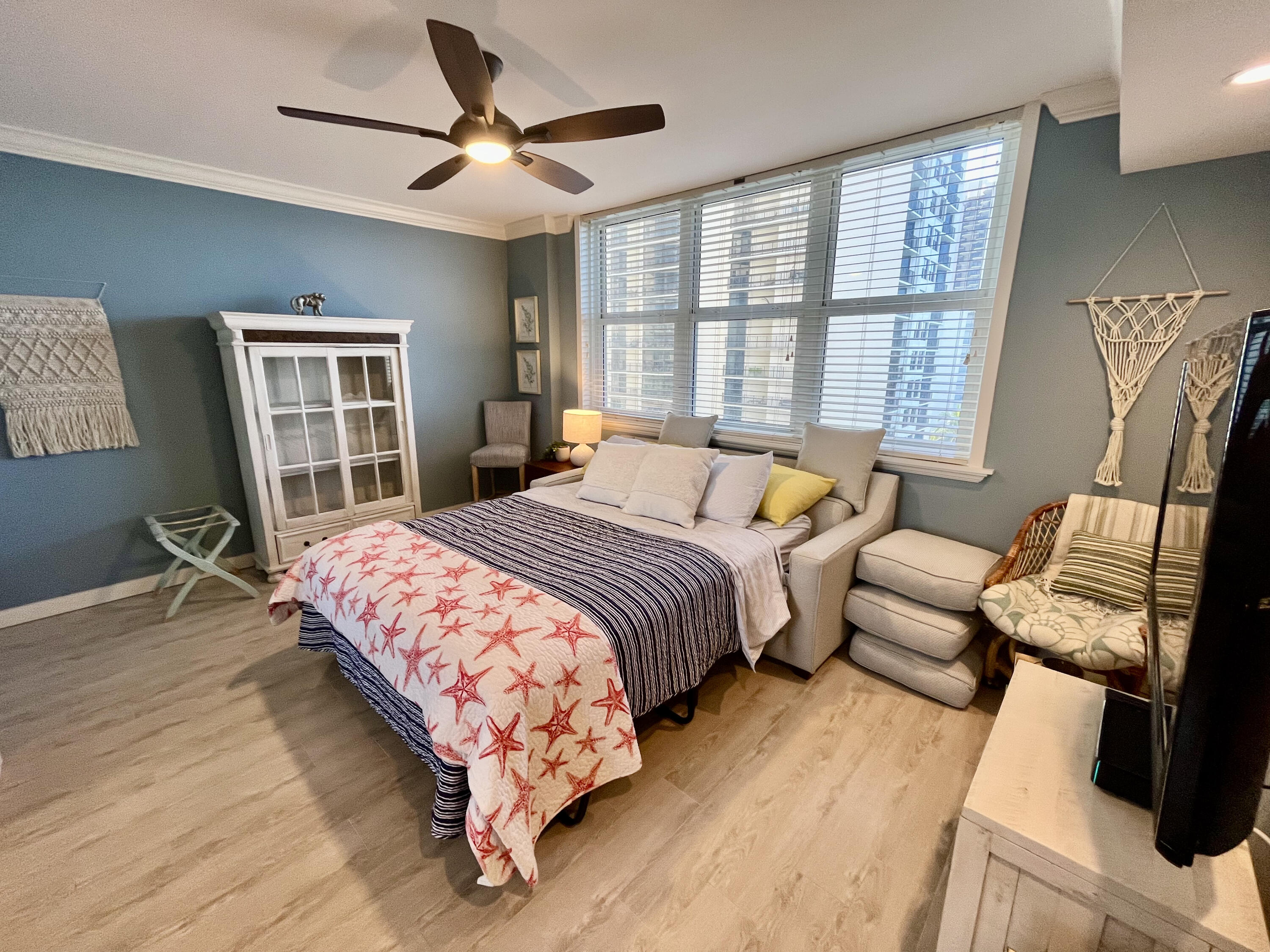 5440 North Ocean Drive, Unit 601 Riviera Beach, FL 33404 - Photo 24 of 55 a bedroom with a bed wooden floor and a window