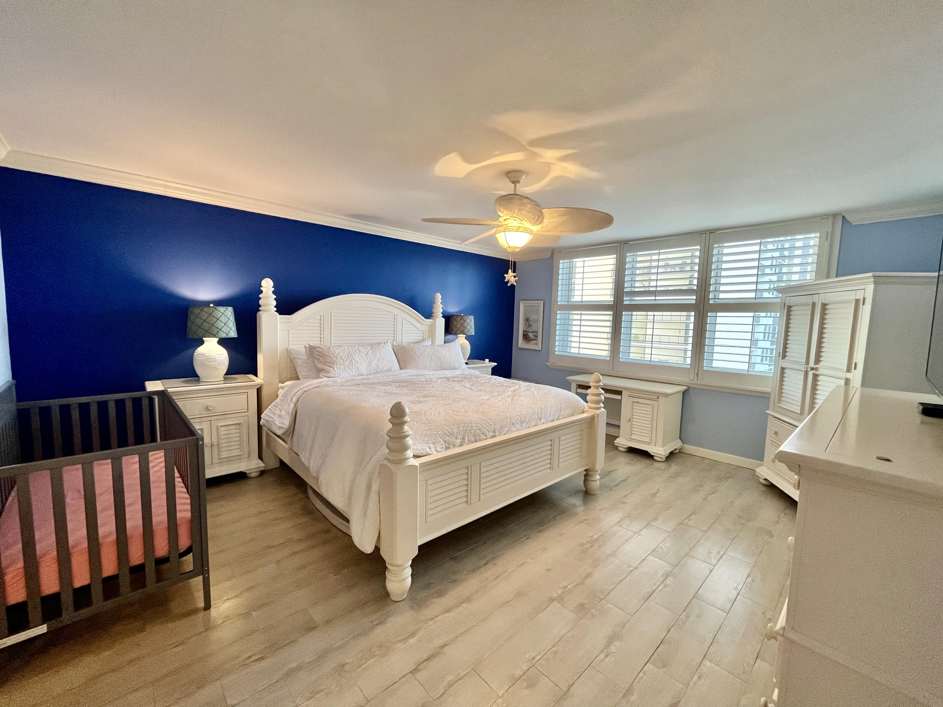 5440 North Ocean Drive, Unit 601 Riviera Beach, FL 33404 - Photo 26 of 55 a bedroom with a bed and wooden floor