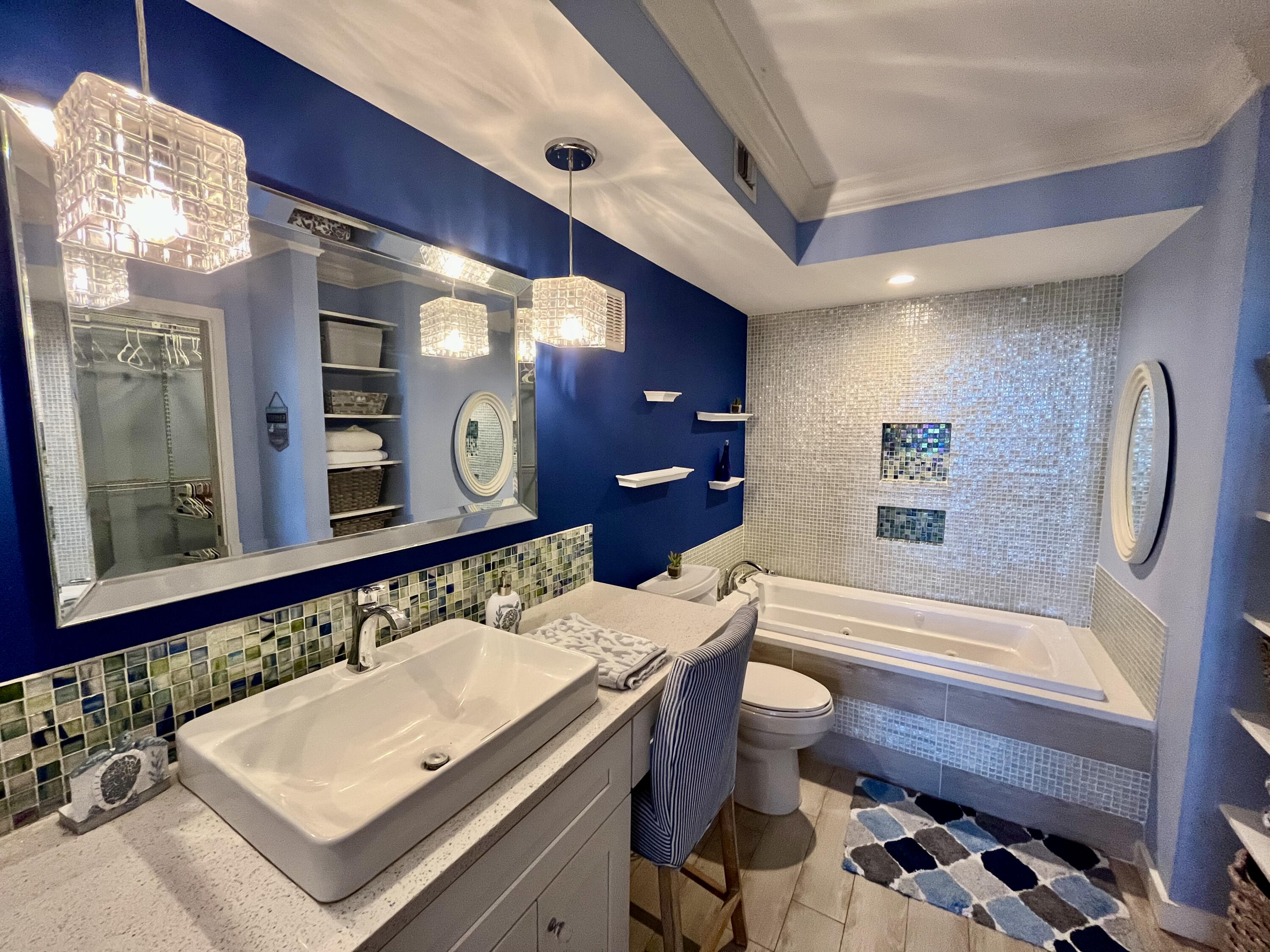 5440 North Ocean Drive, Unit 601 Riviera Beach, FL 33404 - Photo 29 of 55 a bathroom with a sink a toilet a mirror and shower