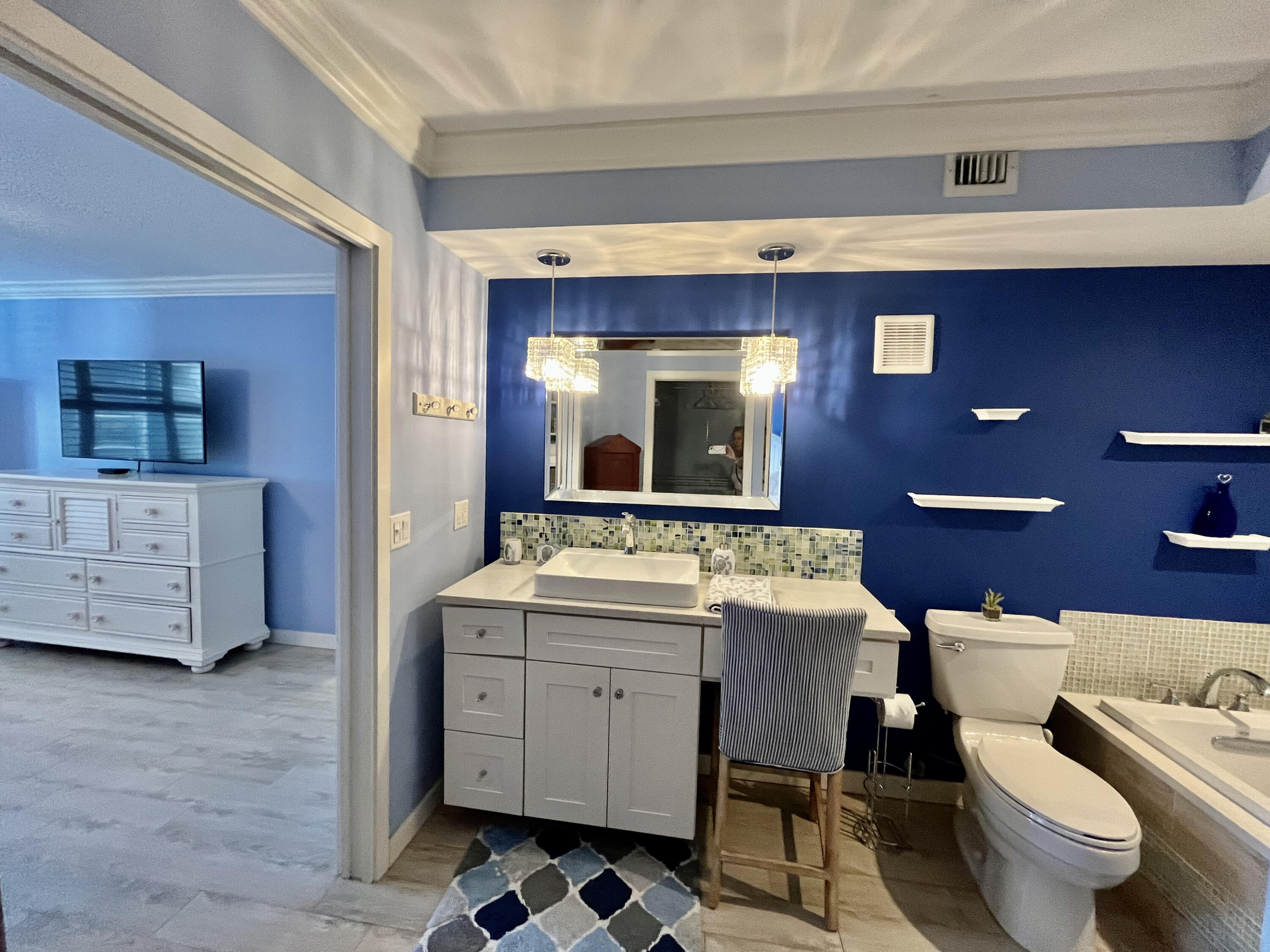 5440 North Ocean Drive, Unit 601 Riviera Beach, FL 33404 - Photo 30 of 55 a bathroom with a toilet a sink and a mirror