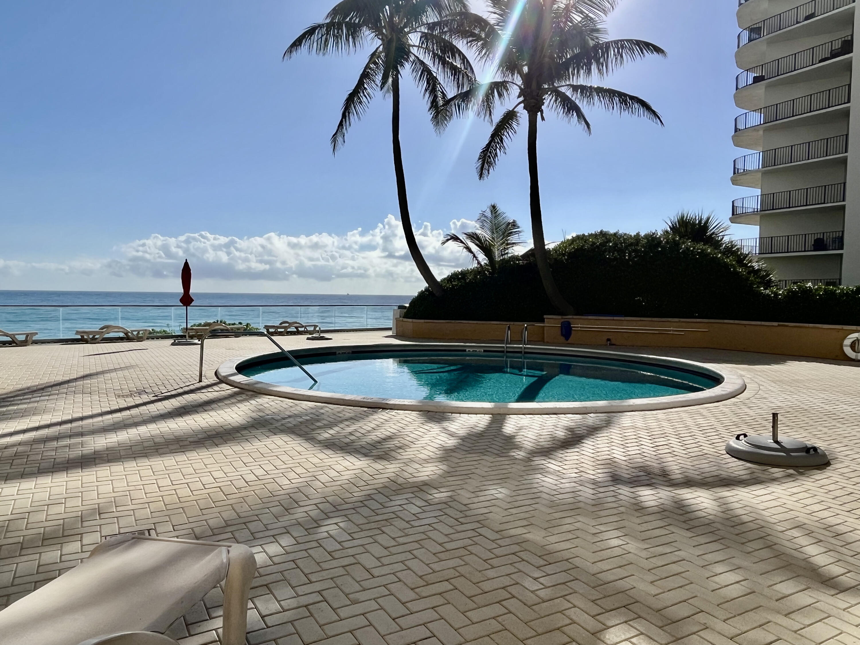 5440 North Ocean Drive, Unit 601 Riviera Beach, FL 33404 - Photo 40 of 55 a view of a swimming pool with a table and chairs