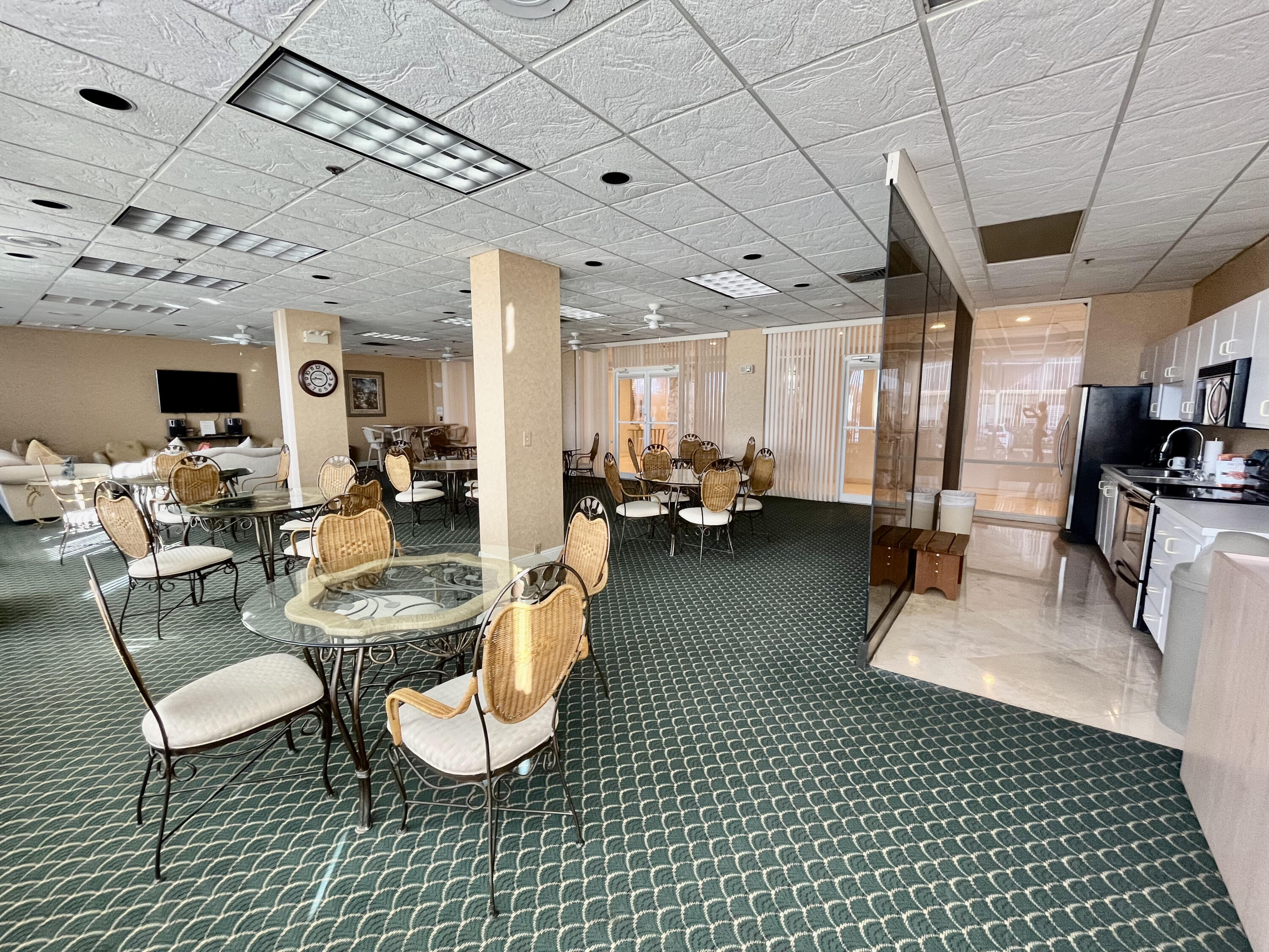 5440 North Ocean Drive, Unit 601 Riviera Beach, FL 33404 - Photo 44 of 55 a living room with lots of furniture and a chandelier