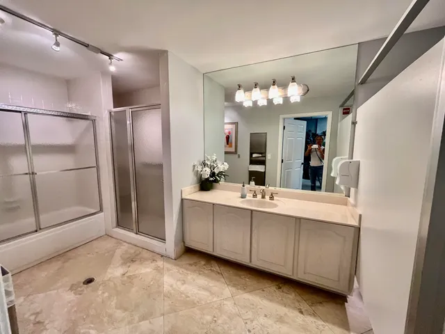 a bathroom with a shower and closet