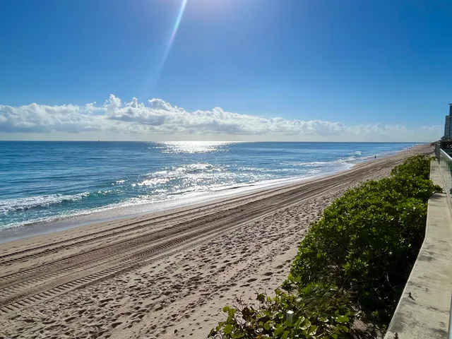 a kitchen with stainless steel appliances wooden floor dining table and chairs