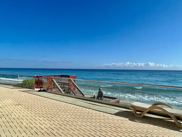 a kitchen with a sink a stove and chairs