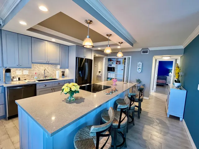 a kitchen with a table chairs stove and wooden floor