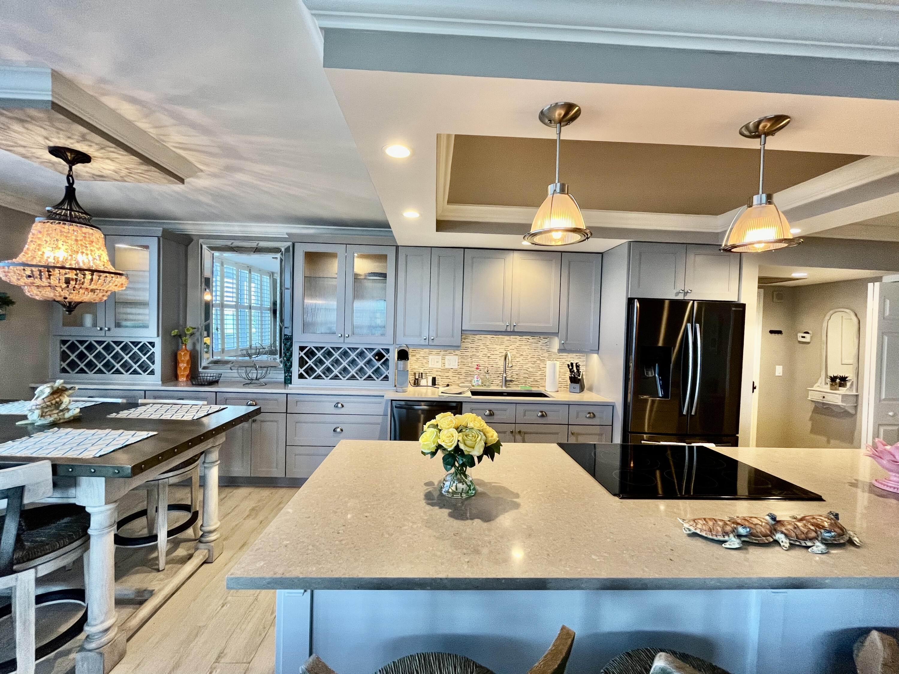 5440 North Ocean Drive, Unit 601 Riviera Beach, FL 33404 - Photo 9 of 55 a kitchen with a sink a stove and chairs