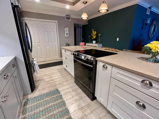 a kitchen with stainless steel appliances a refrigerator and a stove top oven