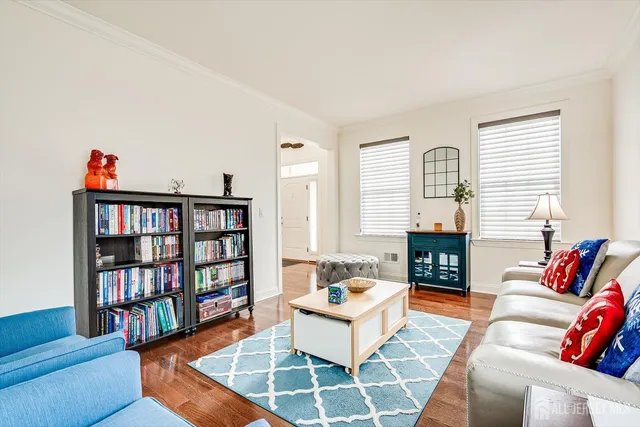 a kitchen with stainless steel appliances granite countertop wooden cabinets a dining table and chairs