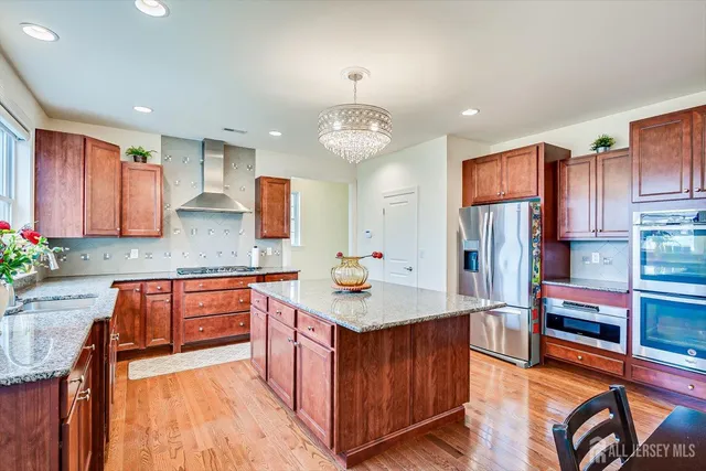 a living room with lots of furniture and paintings on the wall