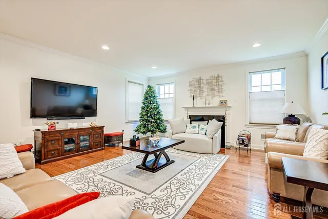 a view of a big room with wooden floor and windows
