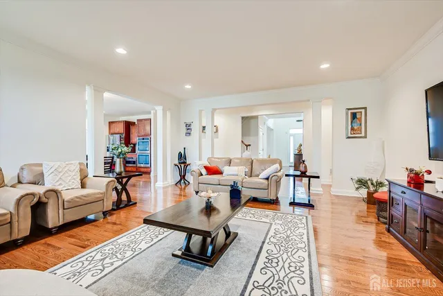 a bedroom with a bed and dresser with mirror